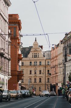 View of a picturesque street in Prague featuring classic European architecture under clear skies.