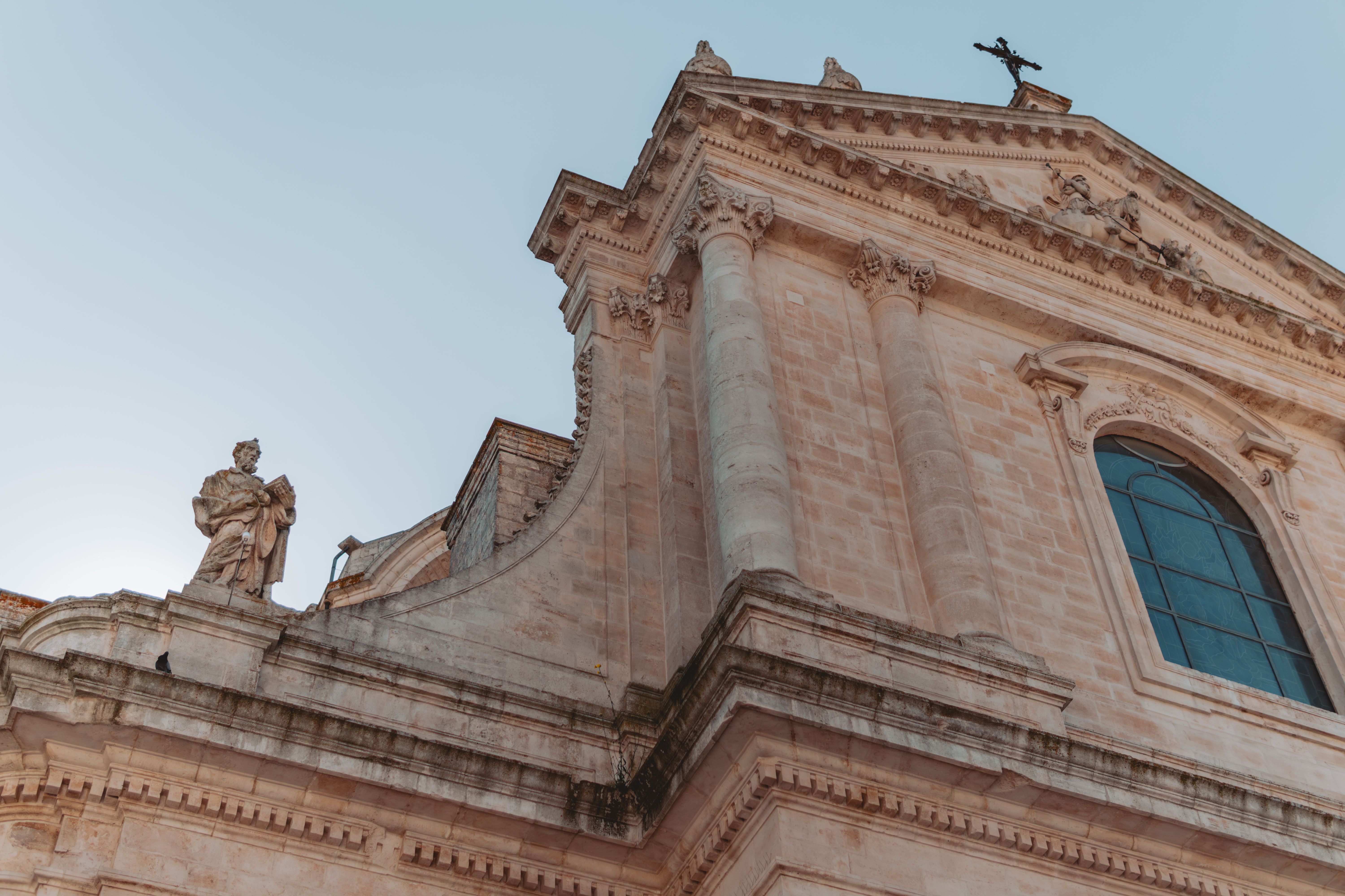 Beautiful architectural detail of a historic building in Locorotondo, Apulia, with clear blue skies.