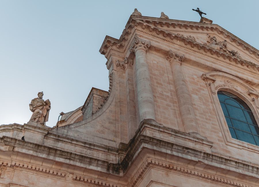 Beautiful architectural detail of a historic building in Locorotondo, Apulia, with clear blue skies.