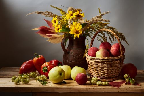 Free A still life composition of autumn harvest fruits and flowers on a wooden table. Stock Photo