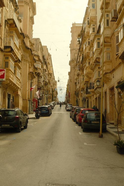 Free Explore the picturesque narrow streets of Valletta, showcasing historic architecture and vibrant urban life. Stock Photo