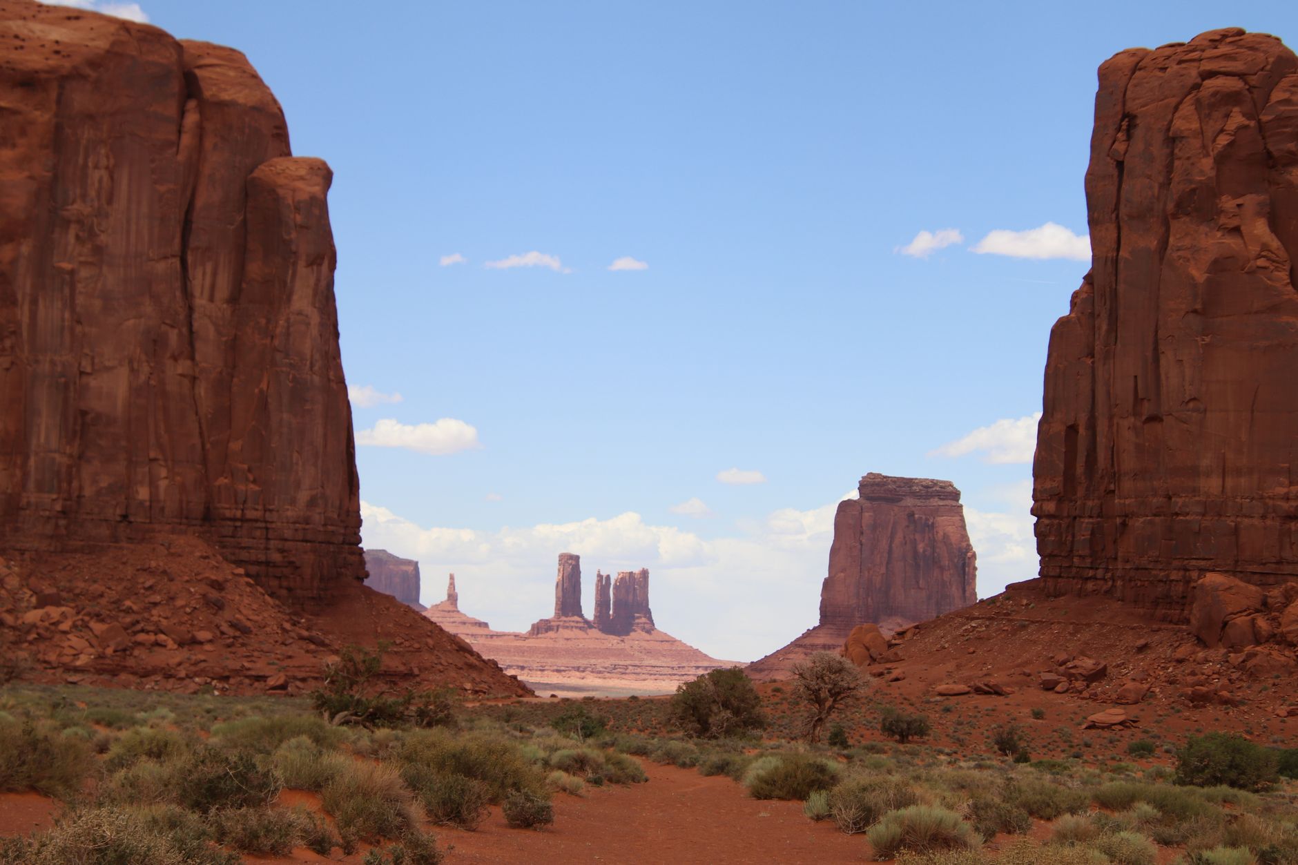 Breathtaking view of towering red rock formations in Monument Valley under a clear blue sky.