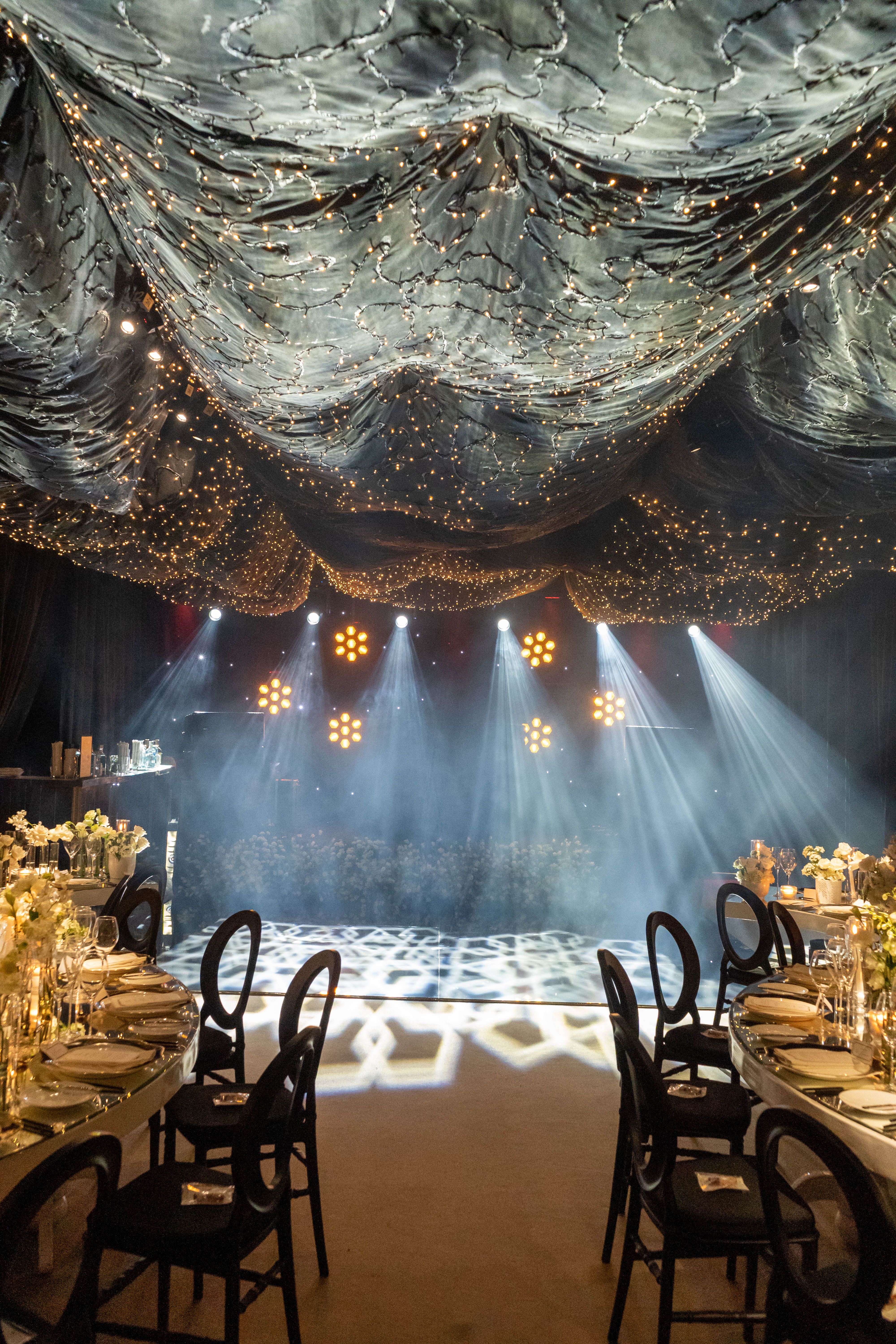 Elegant corporate event with dramatic lighting and styled tables