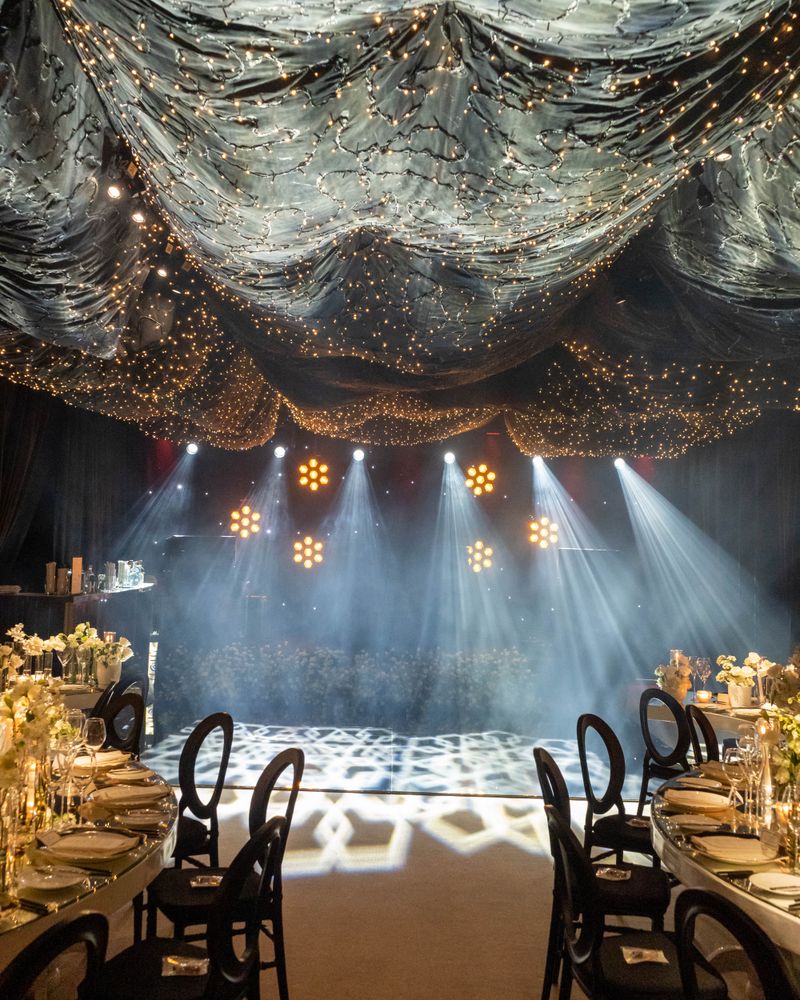 Elegant corporate event with dramatic lighting and styled tables