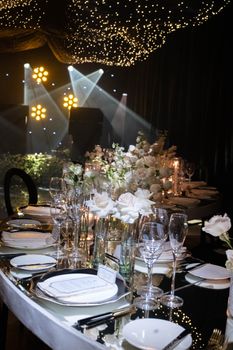 Luxurious wedding table setup with elegant floral arrangements and ambient lighting creating a sophisticated atmosphere.