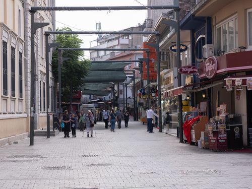 Free A lively street scene in İzmir, Türkiye showcasing people and local shops during the day. Stock Photo