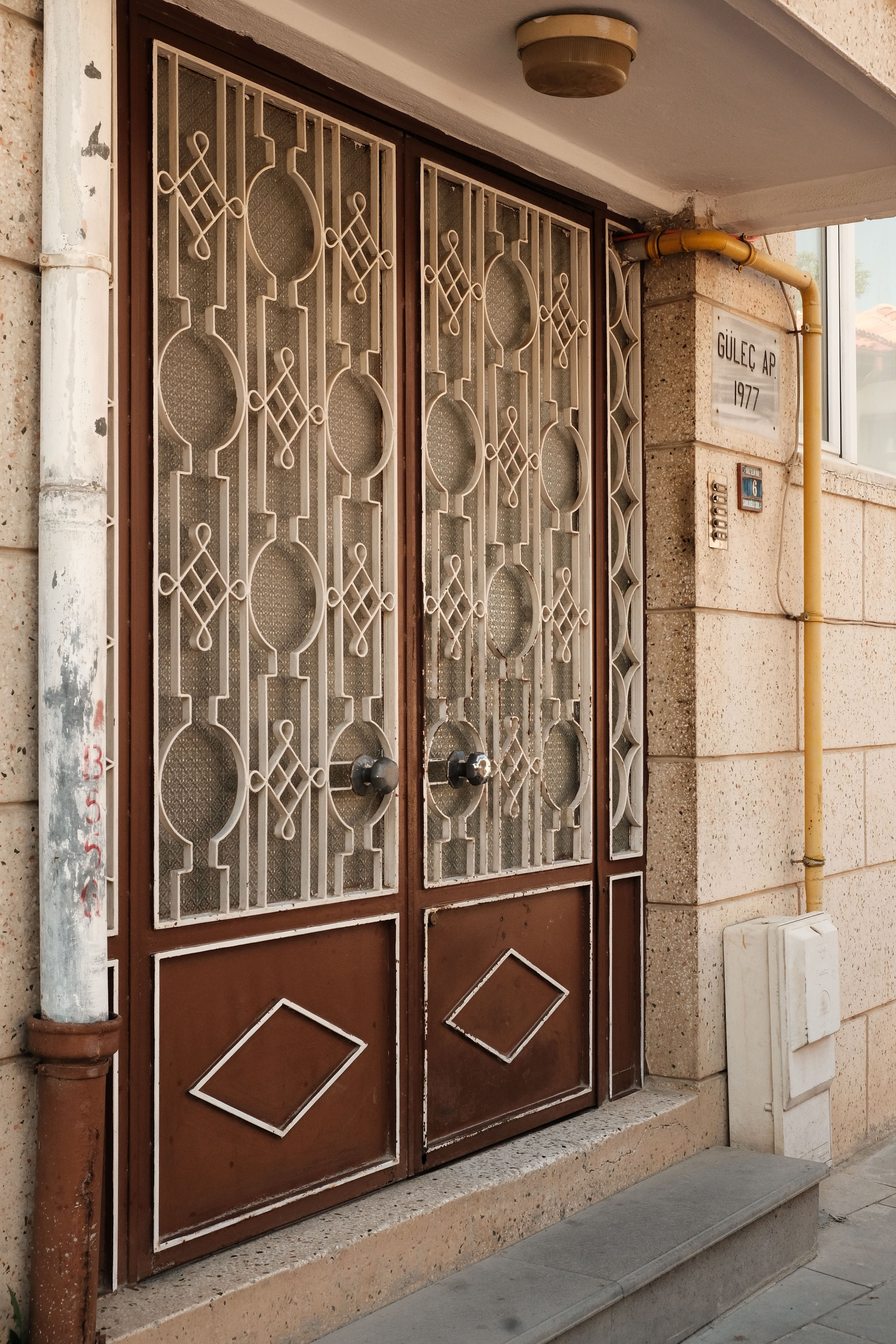 A detailed view of a vintage metal door with decorative patterns on a building in Kastamonu, Türkiye.