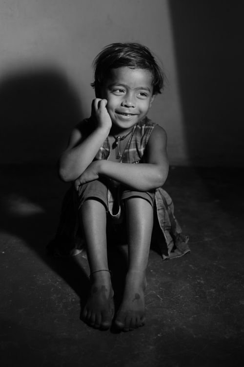 Free Black and white portrait of a thoughtful child in Lalakapa, India, showcasing innocence and quiet reflection. Stock Photo