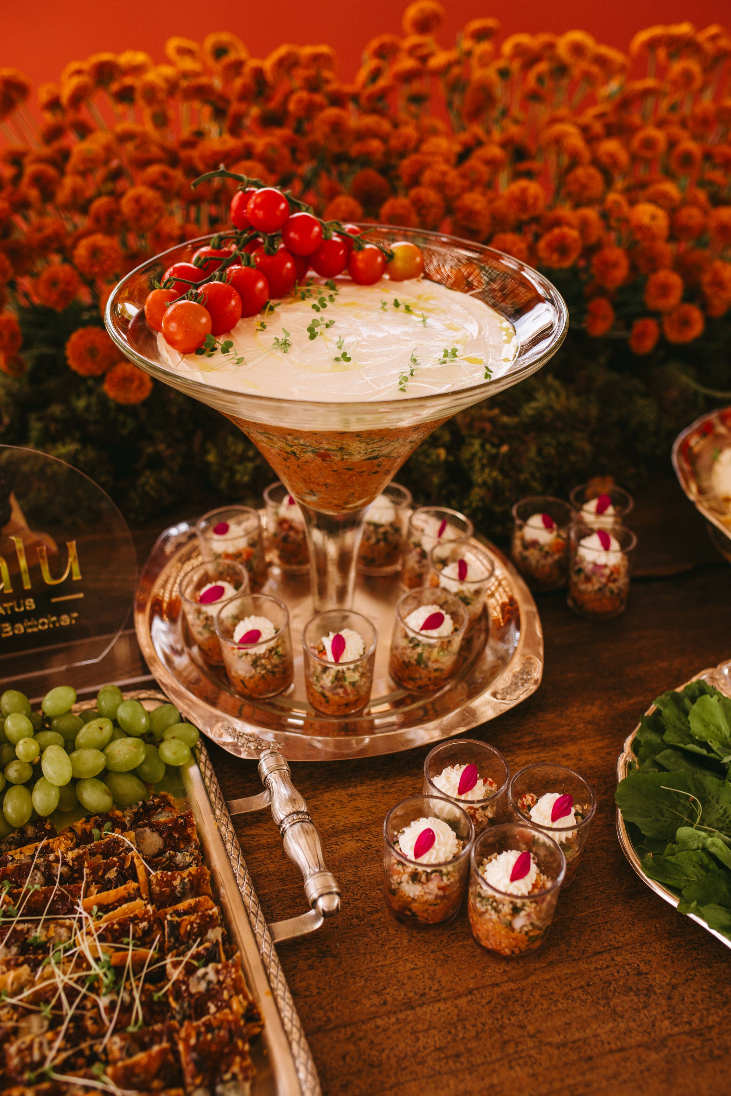 Luxury wedding catering display with abundant appetizers and floral styling