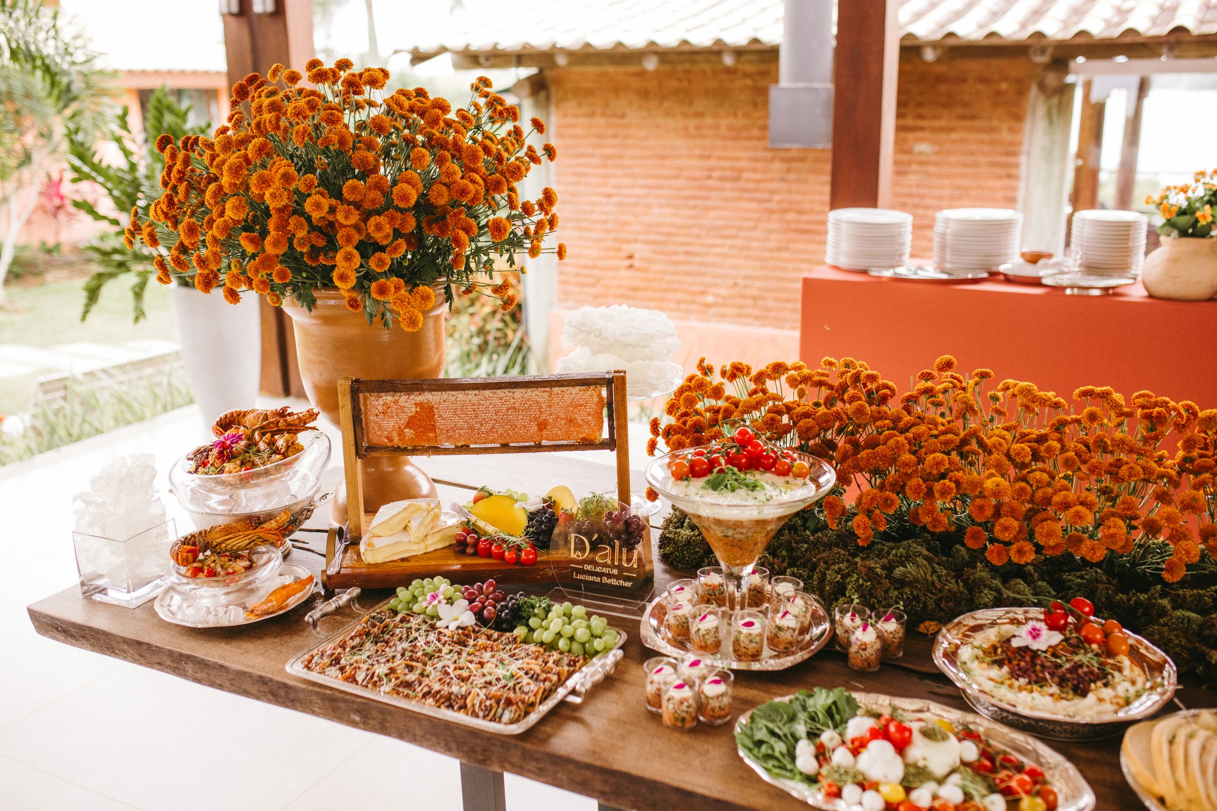 Elegant wedding buffet with orange floral styling and abundant catering presentation