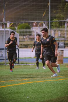 Energetic soccer players running on an outdoor field during a game.