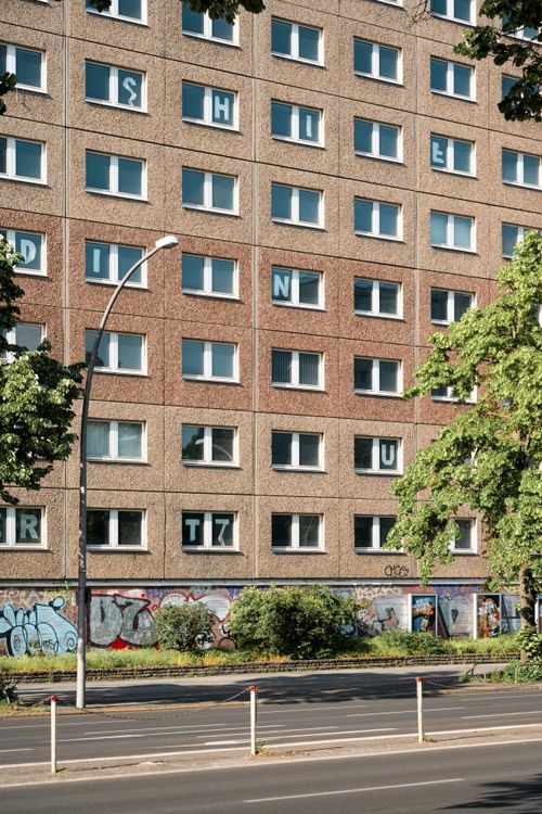 Free Street view of a Berlin Marzahn apartment with graffiti and trees. Stock Photo