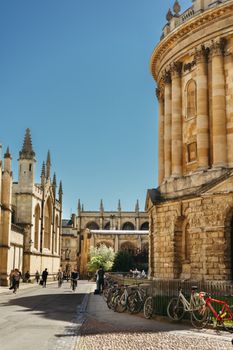 Vibrant daytime view of Oxford University with bicycles and historic architecture.