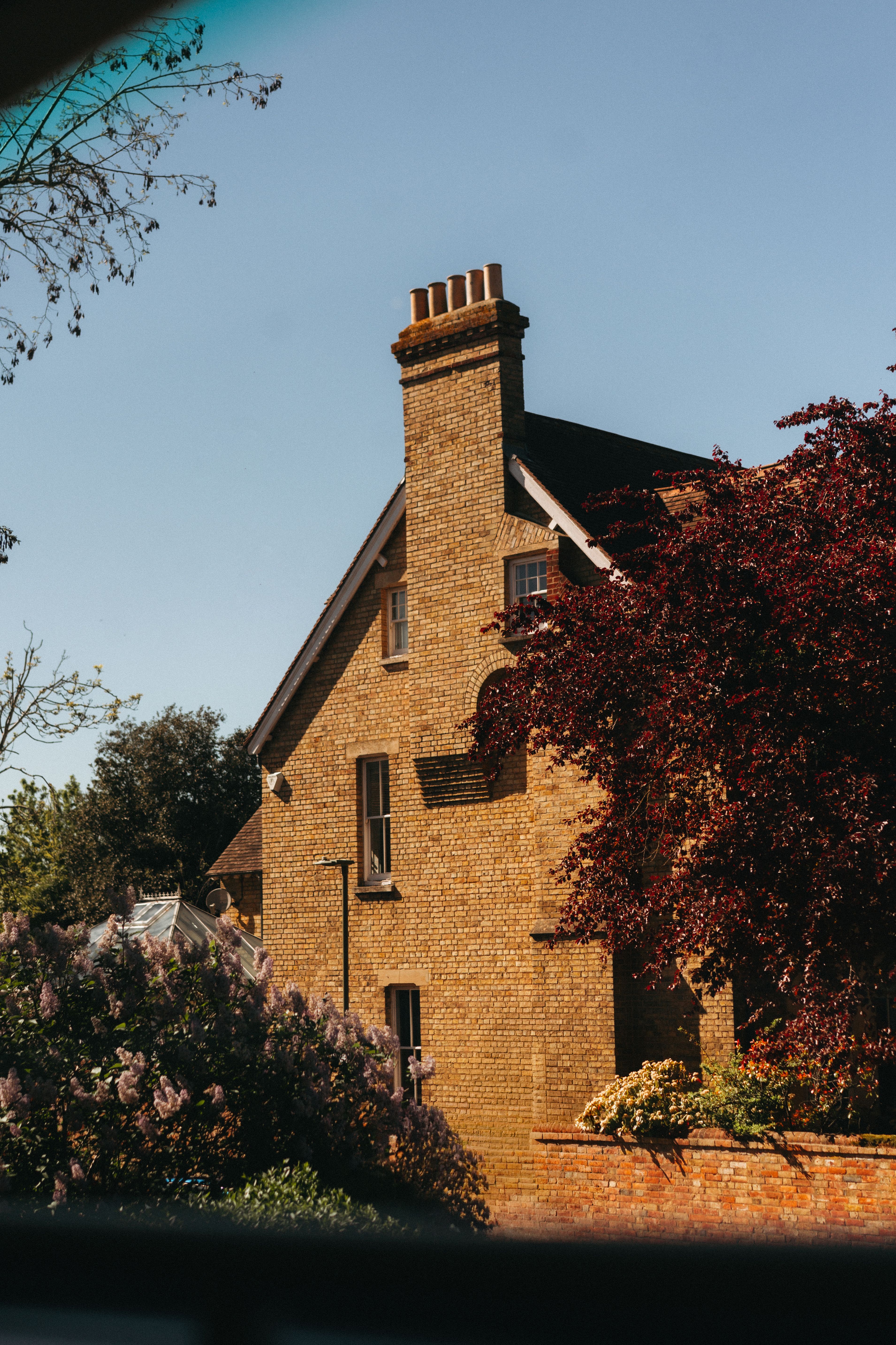 A traditional British brick home in Oxford, England under a clear sky