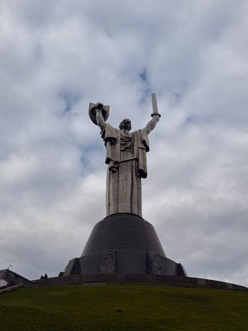 Free The Motherland Monument stands tall in Kyiv against a cloudy sky, symbolizing strength and resilience. Stock Photo