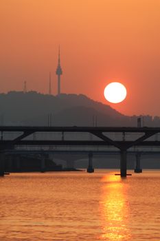 Beautiful sunset view over Han River with Namsan Tower silhouetted, Seoul.