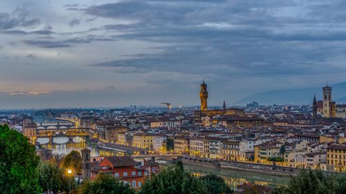 Free Beautiful aerial twilight view of Florence with the iconic Ponte Vecchio and the Arno River. Stock Photo