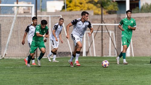 Free Teen soccer players compete on a sunny outdoor field, showcasing teamwork and skill. Stock Photo