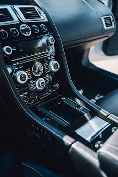 Close-up of a luxury car's interior showcasing a sleek control panel with precision details.