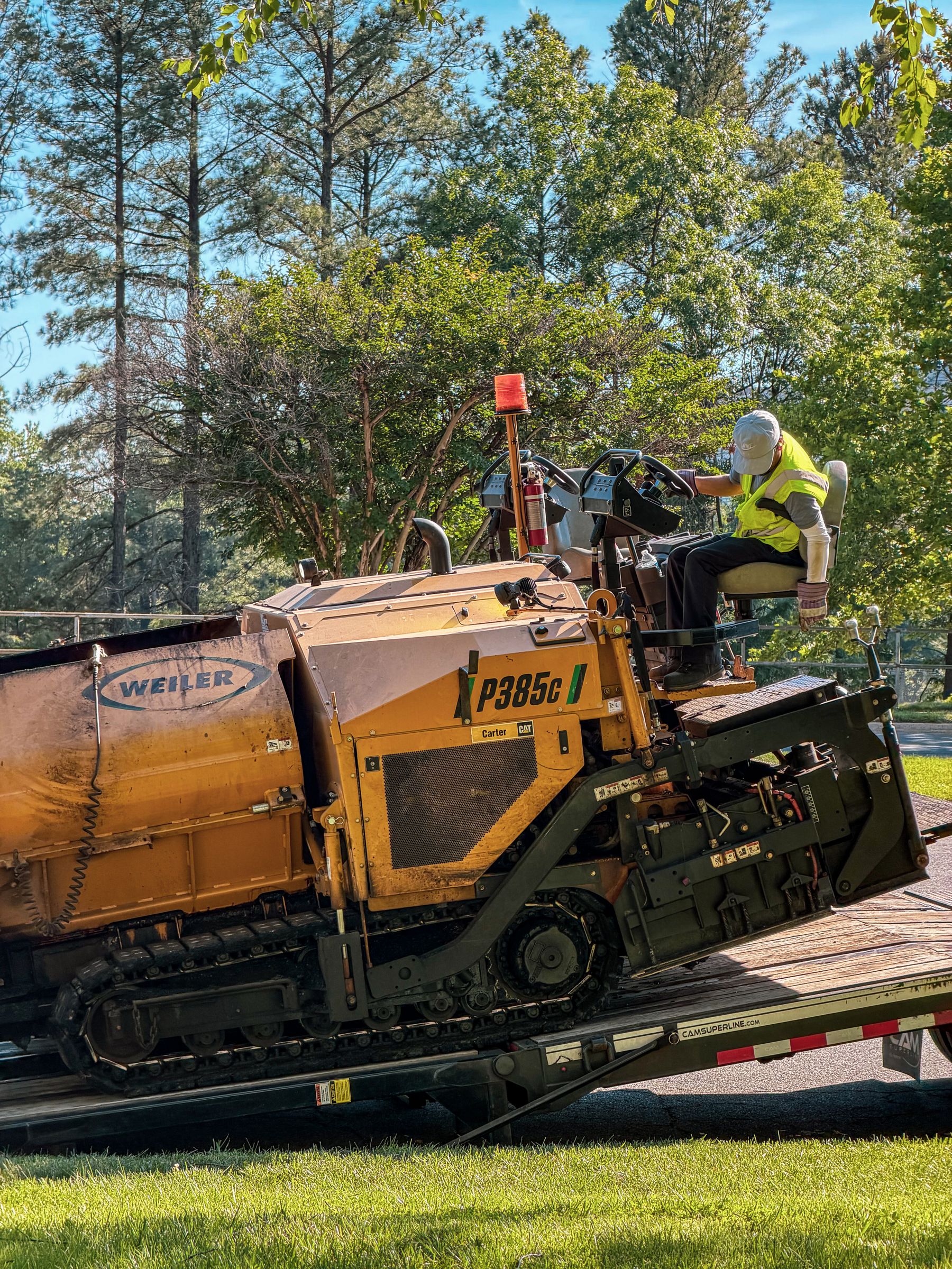 Operator running a paver across a commercial surface
