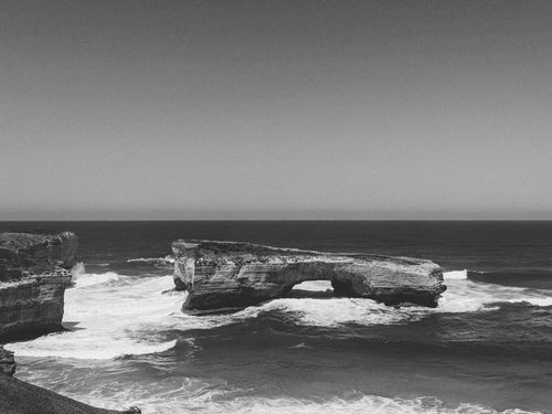 Free Black and white image of rocky formations and waves at Peterborough, VIC, Australia. Stock Photo
