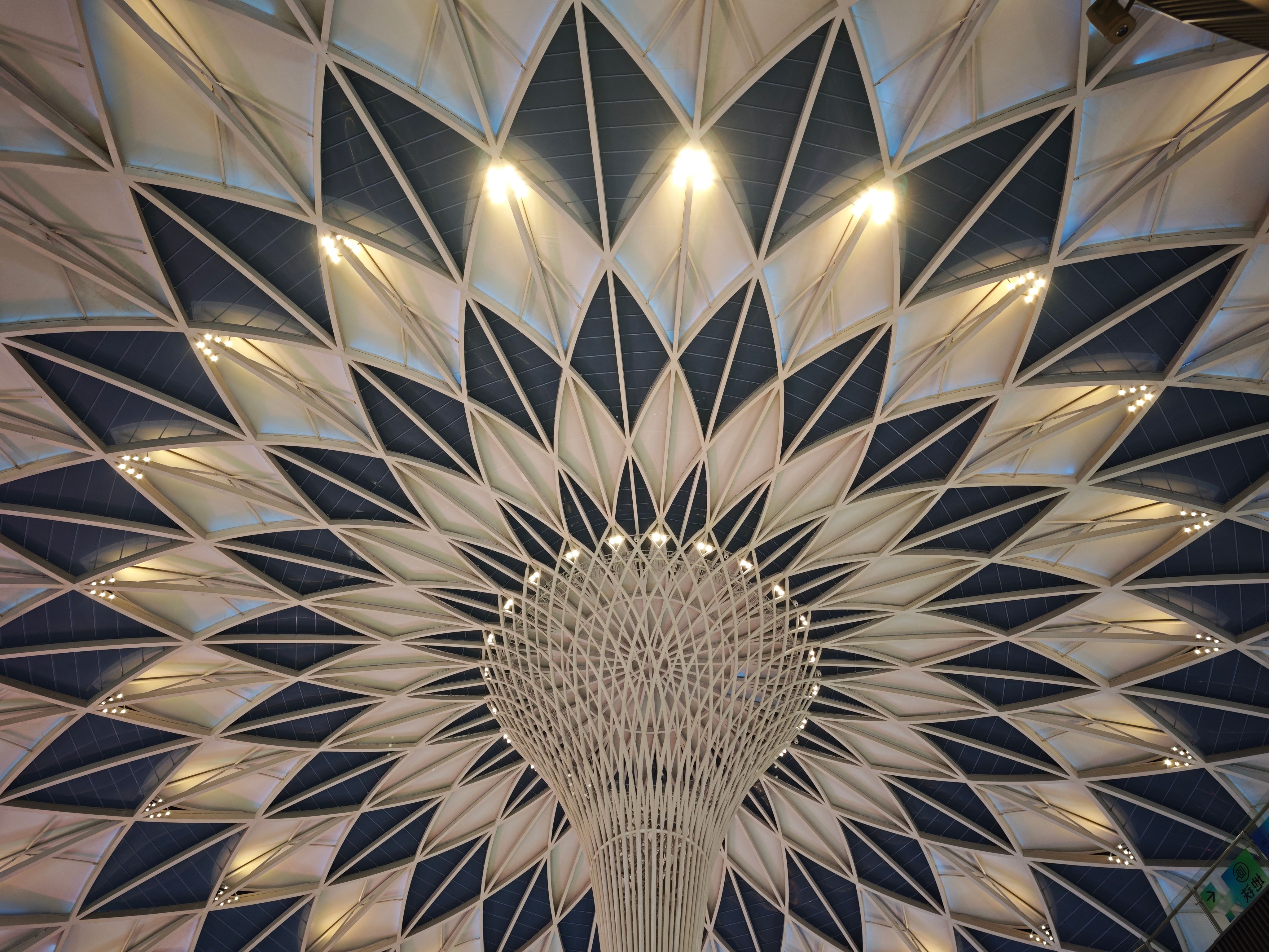 A stunning view of a geometric dome ceiling showcasing intricate architectural design and lighting.
