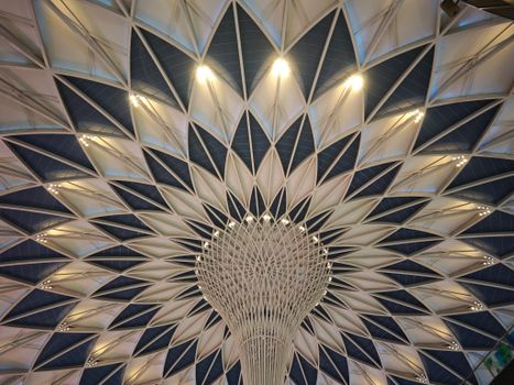 A stunning view of a geometric dome ceiling showcasing intricate architectural design and lighting.