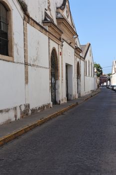 Charming street in El Puerto de Santa María featuring traditional architecture, captured in a serene daytime setting.