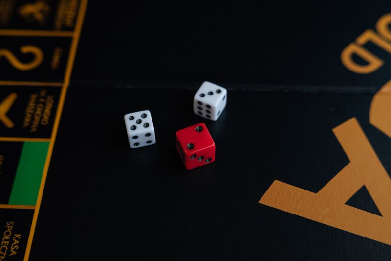 A close-up of red and white dice on a board game, evoking a sense of fun and strategy.