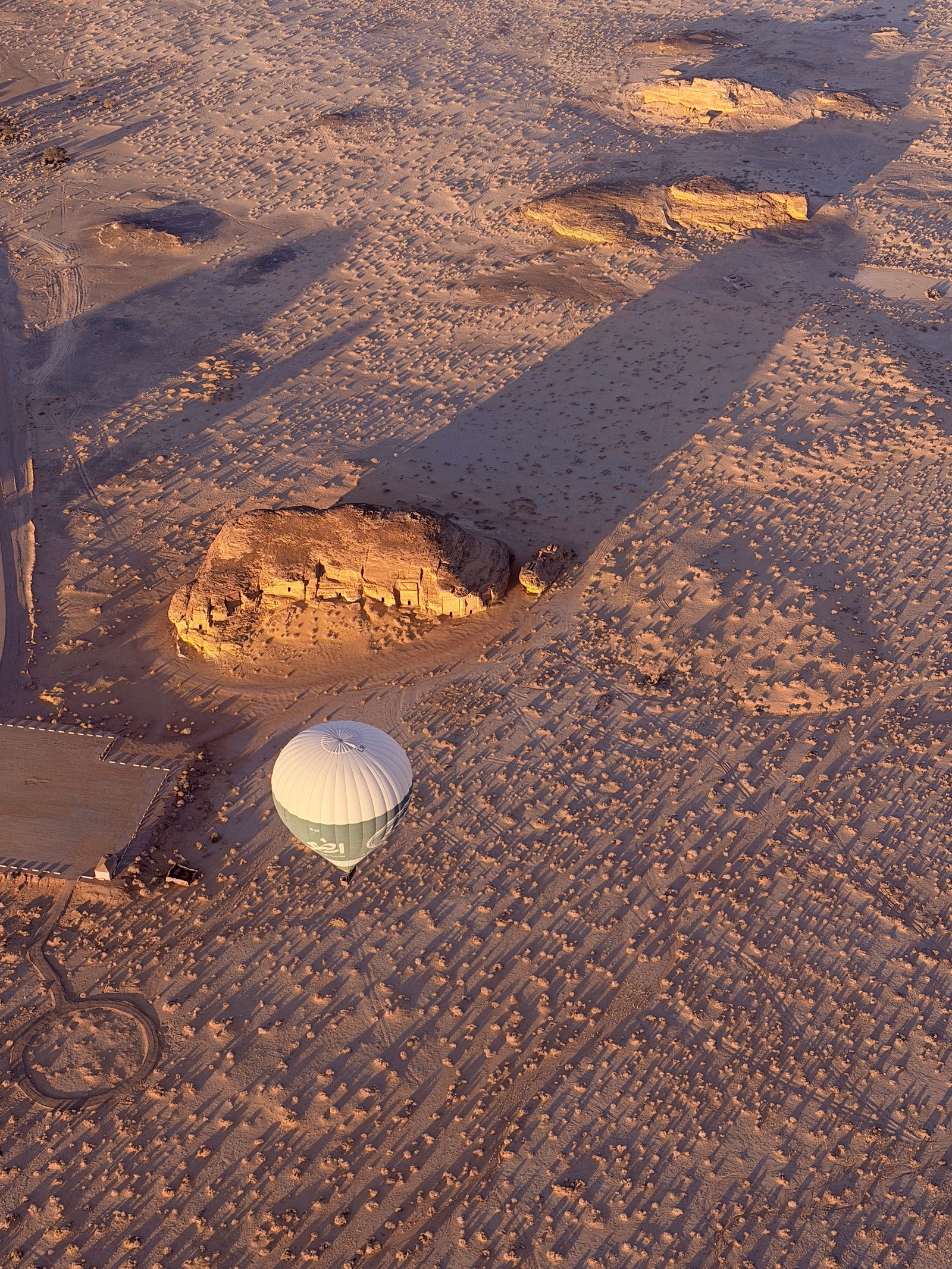 Hot air balloons over AlUla desert at sunrise