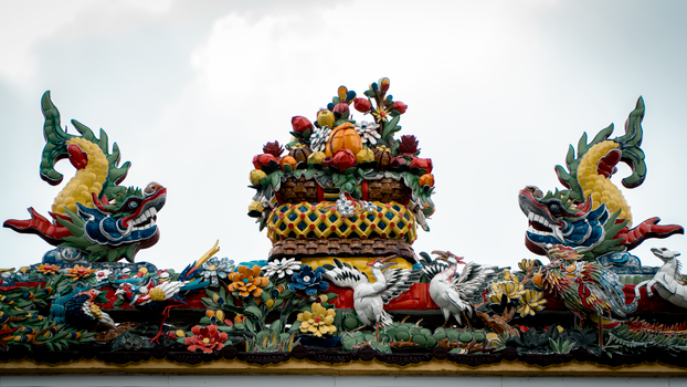 Vibrant decorative roof featuring dragons and colorful floral patterns.