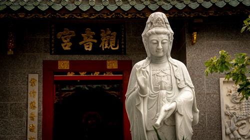 Free Elegant Guanyin statue in a serene temple setting, capturing the essence of tranquility. Stock Photo