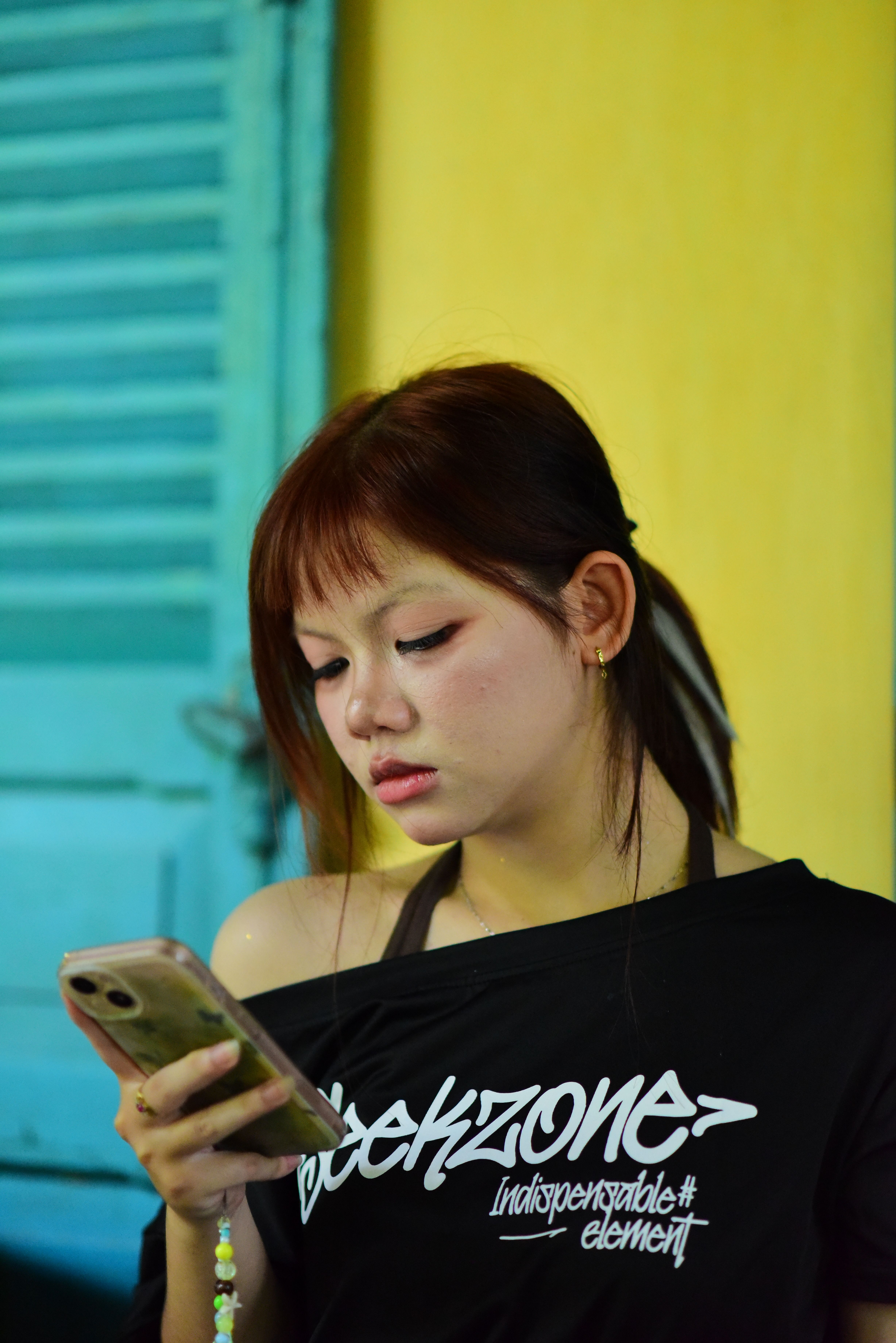 Young Woman Engaged with Smartphone Indoors
