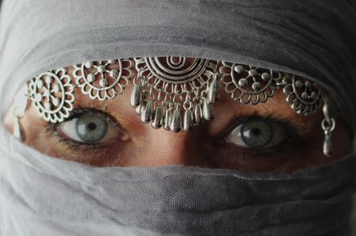 Free Captivating image of mysterious eyes peering through a veil adorned with ornate jewelry. Stock Photo