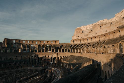 Free Explore the ancient Colosseum's architecture under a clear sky in Rome, Italy. Stock Photo