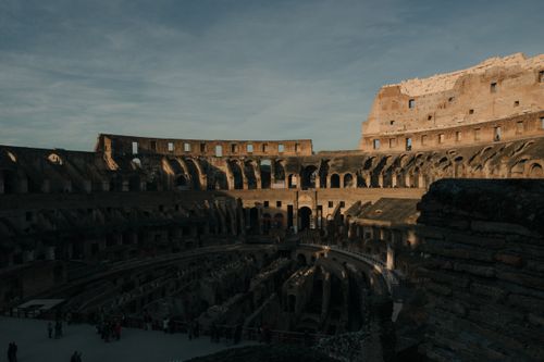 Free A captivating view of the Colosseum interior in Rome, showcasing its ancient architectural grandeur. Stock Photo