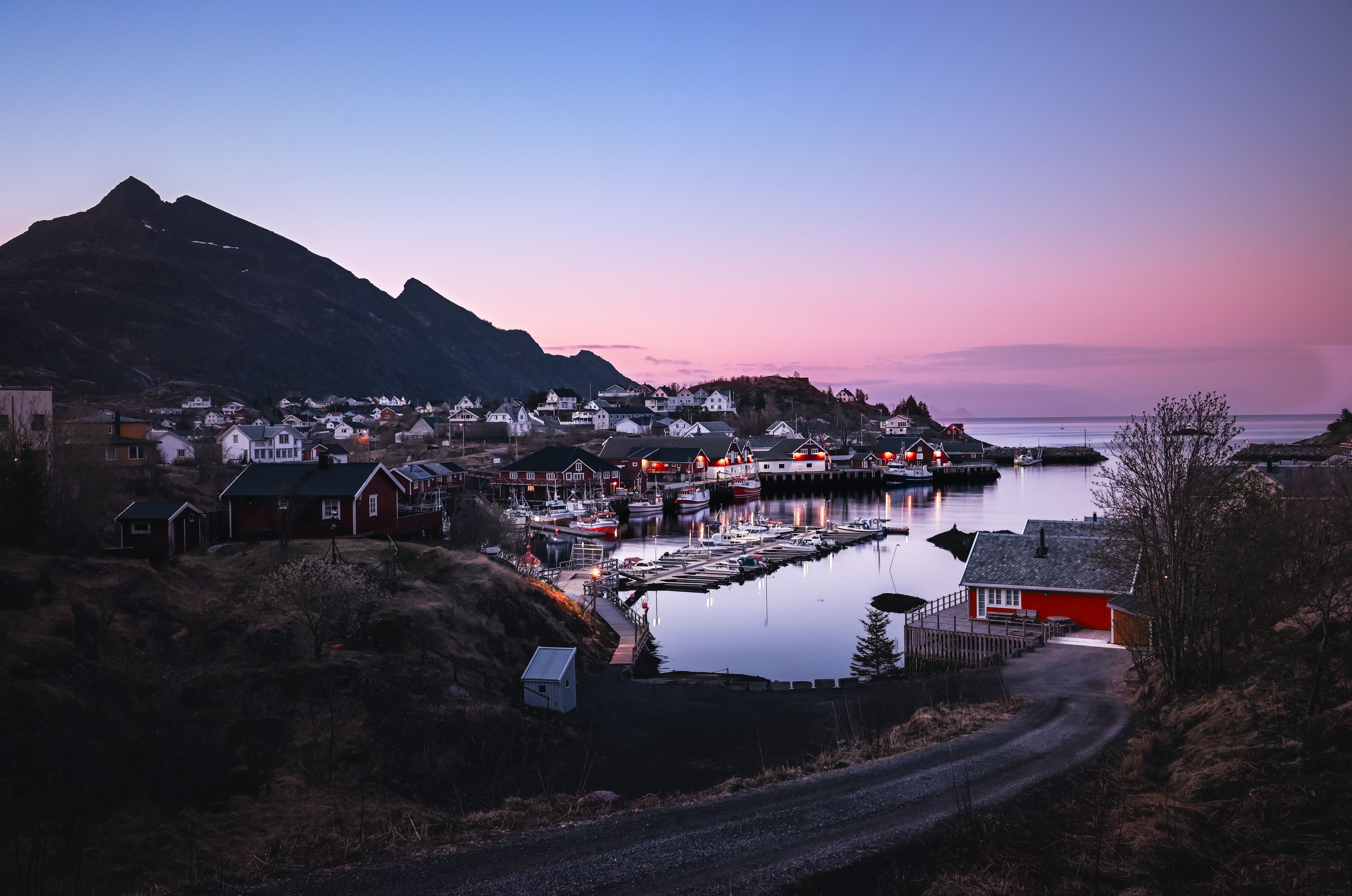 Scenic view of a Nordic fjord village at twilight, capturing the serene beauty of Comté de Nordland, Norway.