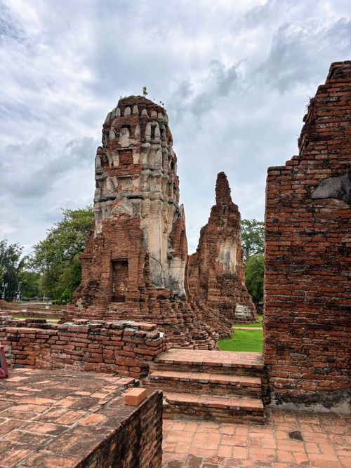 Free Explore the red brick ruins of Ayutthaya Historical Park under a cloudy sky. Stock Photo