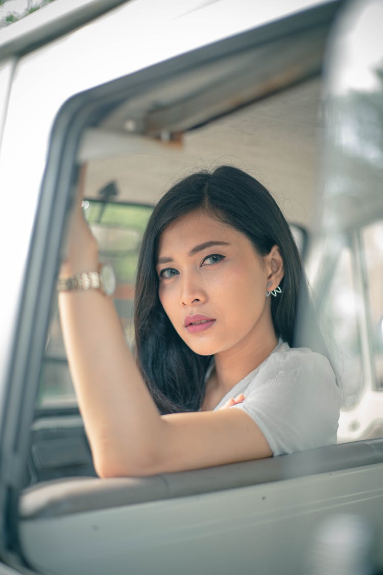 Thoughtful Woman Sitting On Front Seat In Car