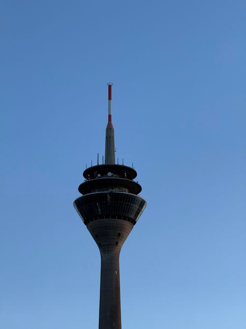 Free Silhouette of Rheinturm Tower in Düsseldorf under a cloudless blue sky. Stock Photo