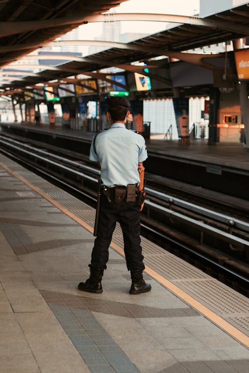 Security Standing on a Platform at a Train Station