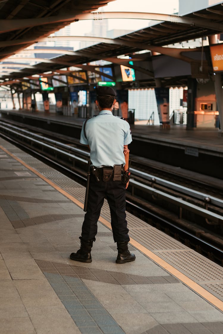 Security Standing On A Platform At A Train Station