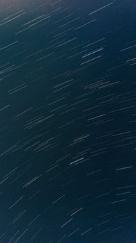 Captivating long-exposure shot of star trails streaking across the night sky.
