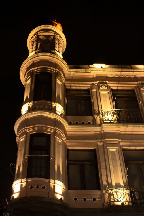 Free Beautifully illuminated historic hotel building in Puebla, Mexico, showcasing artistic window design. Stock Photo