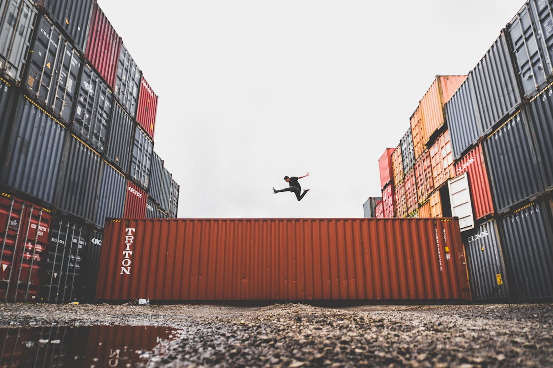 Free Man Jumping on Intermodal Container Stock Photo