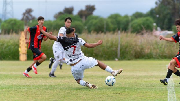 Exciting action moment during a youth soccer match, players competing outdoors.