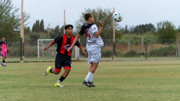 Exciting soccer match with young players in action on a grassy field.