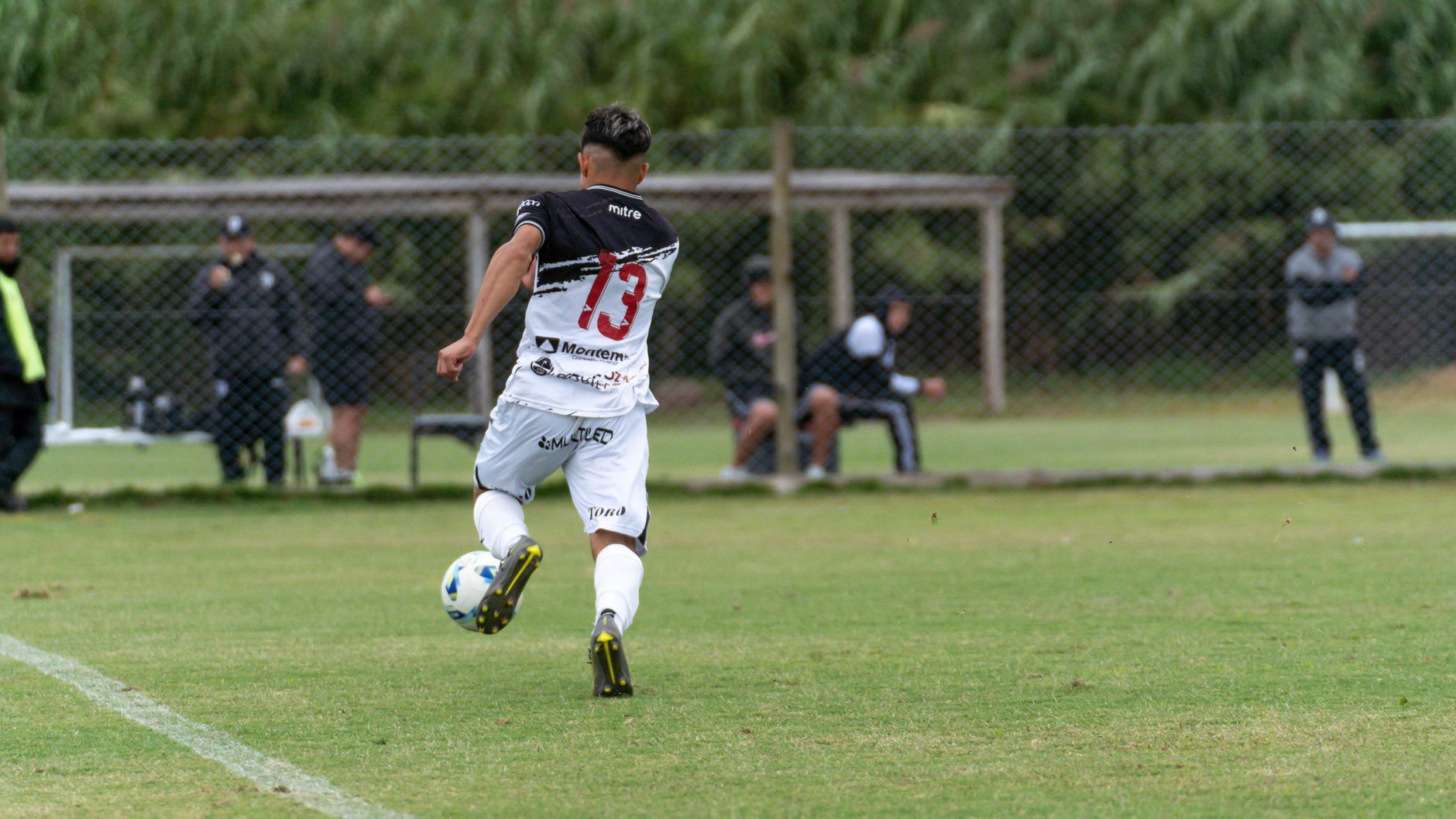 midfielder scanning over his shoulder before receiving a pass during an intense small-sided game