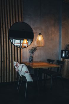 Stylish restaurant corner featuring elegant lighting and contemporary design, perfect for a cozy dining experience.