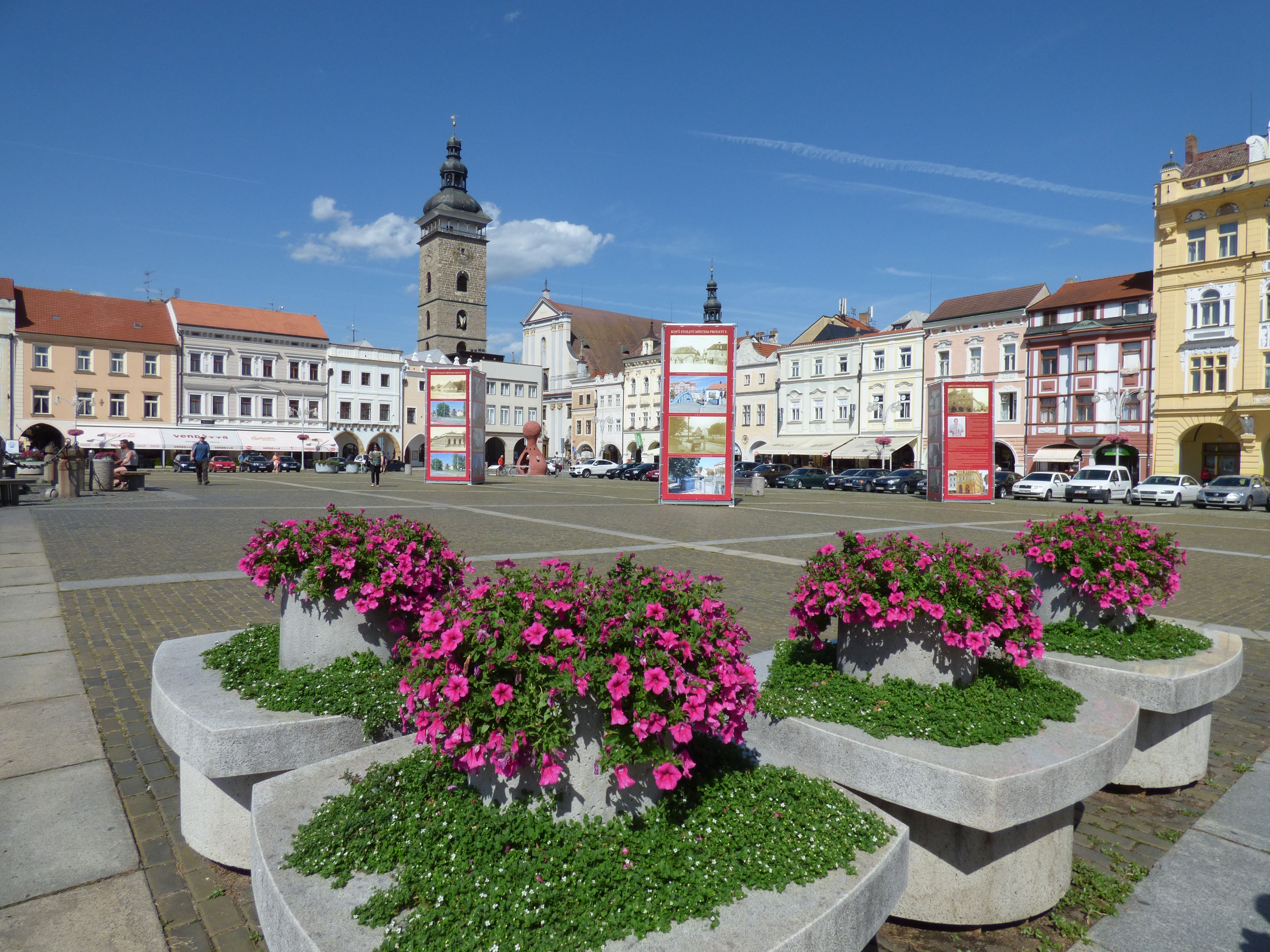 Beautiful historic town square with vibrant flowers in České Budějovice, Czech Republic.